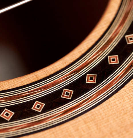 Closeup of the rosette of a 2023 Jochen Rothel classical guitar made with cedar top and African rosewood back and sides