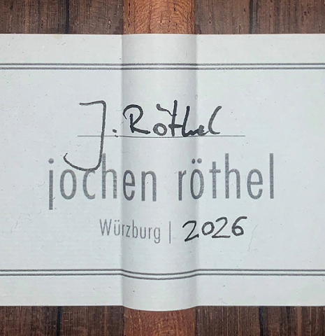 The label of a 2026 Jochen Röthel classical guitar made of cedar and African rosewood