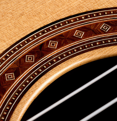 Detailed closeup of the rosette of a 2026 Jochen Röthel classical guitar made of cedar and African rosewood