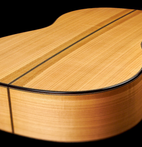 The cherry back and sides of a 2022 Jochen Rothel classical guitar made with spruce top