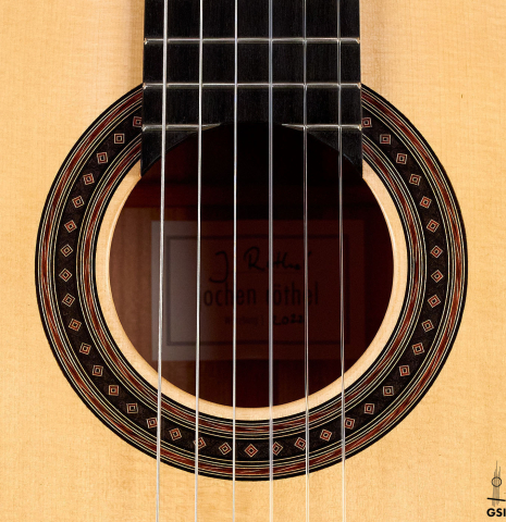 The rosette of a 2022 Jochen Rothel classical guitar made with spruce top and cherry back and sides