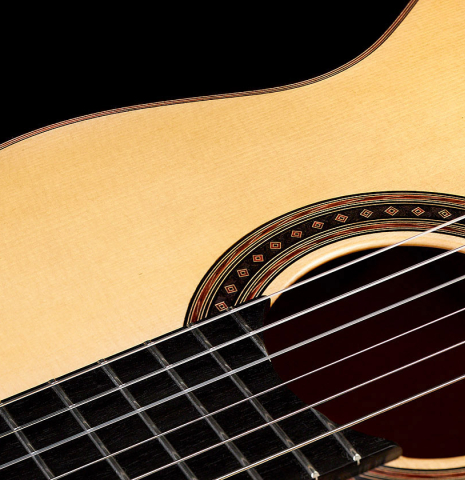 The spruce soundboard of a 2022 Jochen Rothel classical guitar made with cherry back and sides