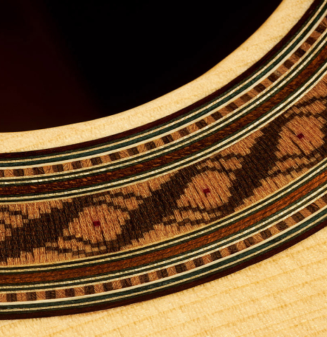 Closeup of the rosette of a 2023 German Vazquez Rubio "Solista" classical guitar made of spruce and Indian rosewood