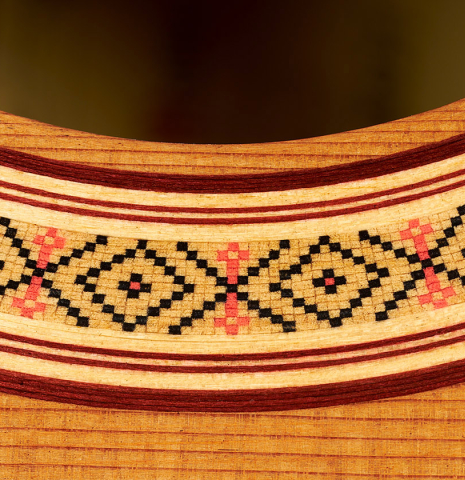 The top and rosette detail of a 2024 German Vazquez Rubio "Classic Estudio" classical guitar made of cedar and palo escrito