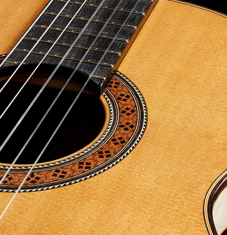 The top and rosette of a 2025 German Vazquez Rubio "Classic Estudio" classical guitar made of cedar and palo escrito