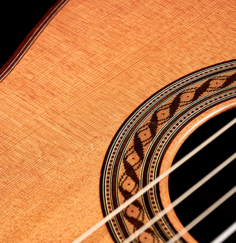 The soundboard and rosette of a 2022 German Vazquez Rubio "Solista" classical guitar made with cedar and Indian rosewood The soundboard and rosette of a 2022 German Vazquez Rubio "Solista" classical guitar made with cedar and Indian rosewood
