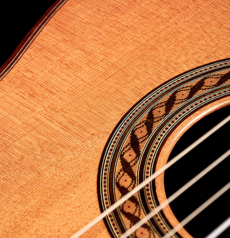 The soundboard and rosette of a 2022 German Vazquez Rubio &quot;Solista&quot; classical guitar made with cedar and Indian rosewood