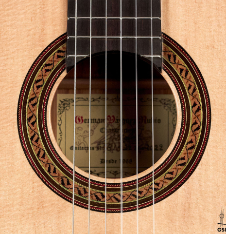 The rosette of a 2022 German Vazquez Rubio &quot;Classic Estudio&quot; classical guitar made of spruce and Palo Escrito.