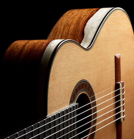 The top and side of a 2024 German Vazquez Rubio "Classic Estudio" classical guitar made of spruce and Palo Escrito.