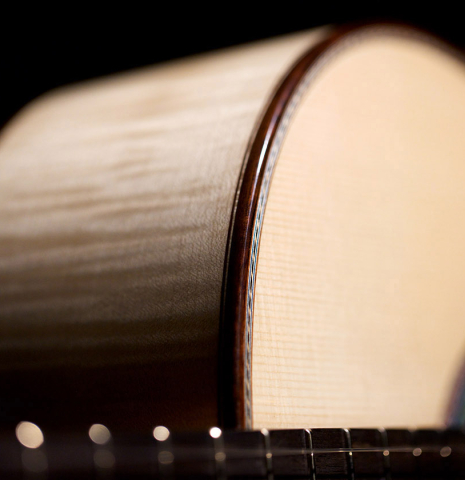The side of a 2021 German Vazquez Rubio "Concert 635" classical guitar made with spruce and maple