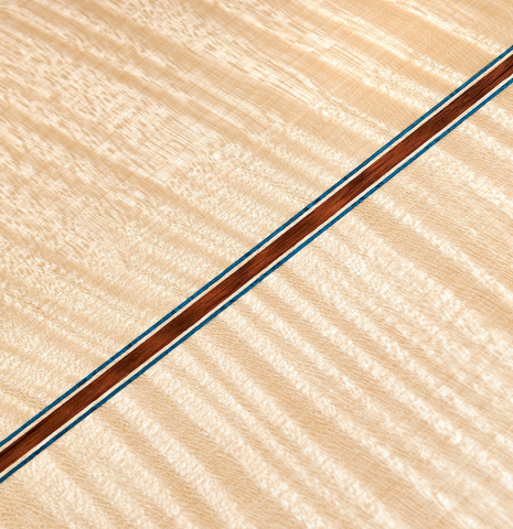 This is the maple back and center seam of a 2023 German Vazquez Rubio "Concert 635" classical guitar made with spruce top and maple back and sides
