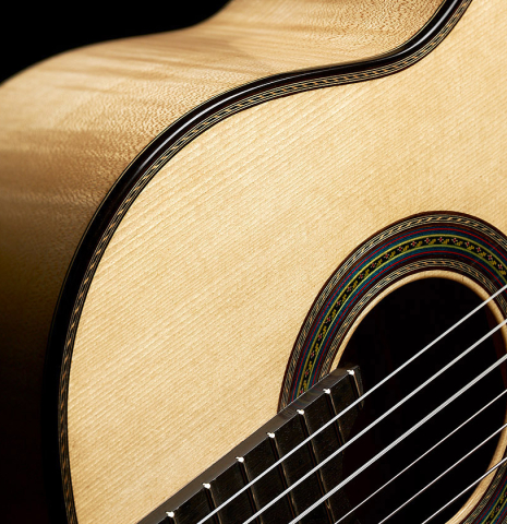 The soundboard and side of a 2023 German Vazquez Rubio "Concert 635" classical guitar made of spruce and maple