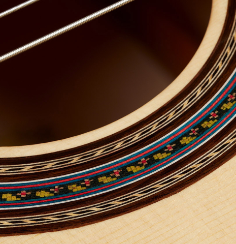 Closeup detail of the rosette of a 2025 German Vazquez Rubio "Concert 635" classical guitar made of spruce and maple