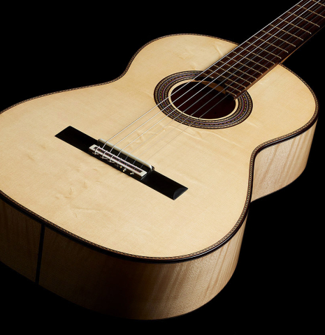 The soundboard of a 2025 German Vazquez Rubio "Concert 635" classical guitar made of spruce and maple