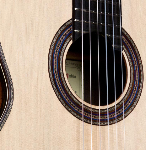 The soundboard of a 2018 German Vazquez Rubio "Concert 635" classical guitar made with spruce and CSA rosewood.