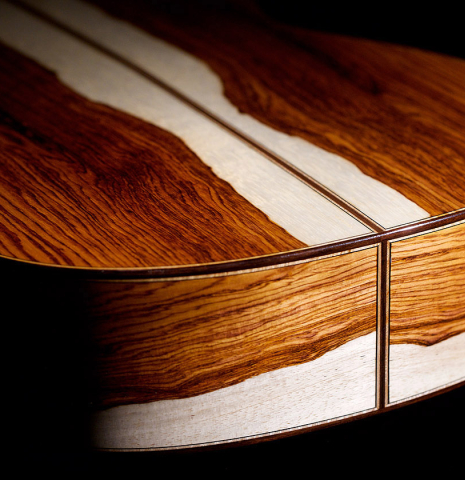 The back and sides at the foot of a 2021 German Vazquez Rubio "Divina" classical guitar made with cedar and palo escrito