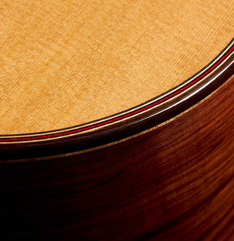 The top binding of a 2024 German Vazquez Rubio "Divina" classical guitar made of cedar and palo escrito