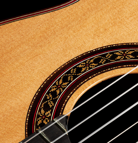 The top and rosette detail of a 2024 German Vazquez Rubio "Divina" classical guitar made of cedar and palo escrito