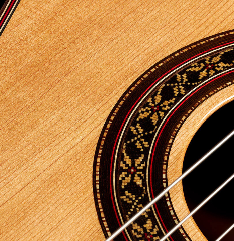 Close-upp detail of the rosette of a 2024 German Vazquez Rubio "Divina" classical guitar made of cedar and palo escrito