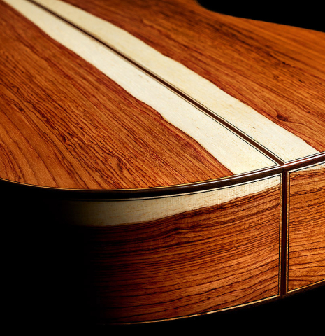 The back and sides of a 2024 German Vazquez Rubio "Divina" classical guitar made of spruce and palo escrito