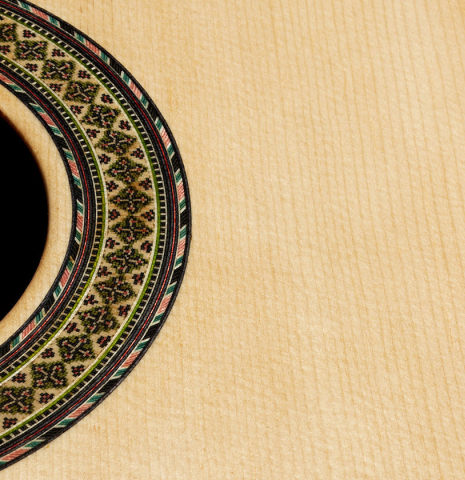 The soundboard and rosette of a 2024 German Vazquez Rubio "Divina" classical guitar made of spruce and palo escrito