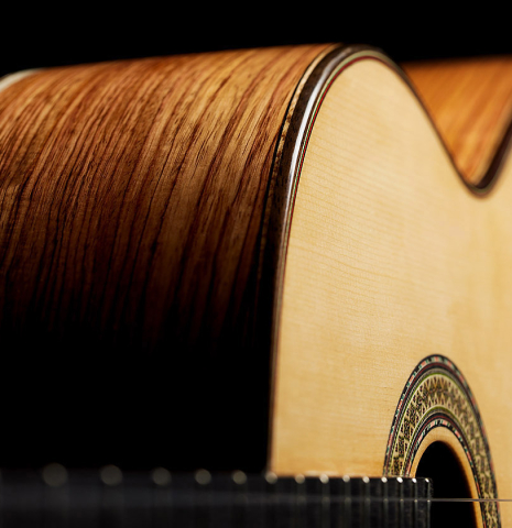 The top and sides of a 2024 German Vazquez Rubio "Divina" classical guitar made of spruce and palo escrito