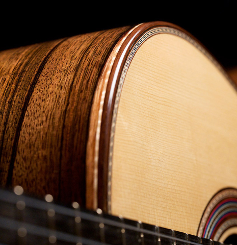 The soundboard, binding and side of a 2021 German Vazquez Rubio "Concert 635" classical guitar made of spruce and ziricote