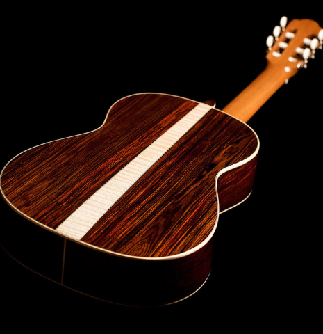 The back and central strip of a 2021 German Vazquez Rubio "Hauser" classical guitar made of spruce and cocobolo