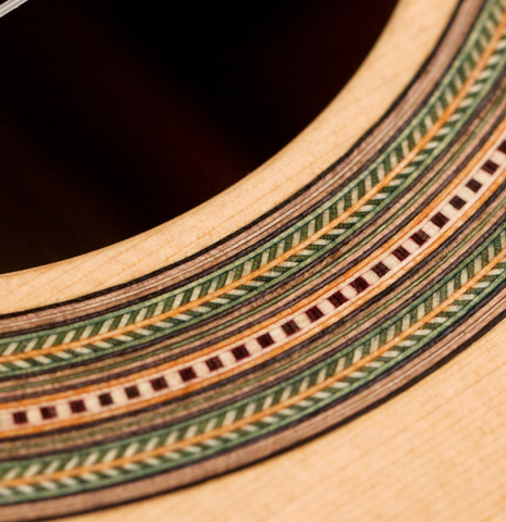 The rosette of a 2021 German Vazquez Rubio &quot;Hauser&quot; classical guitar made of spruce and cocobolo