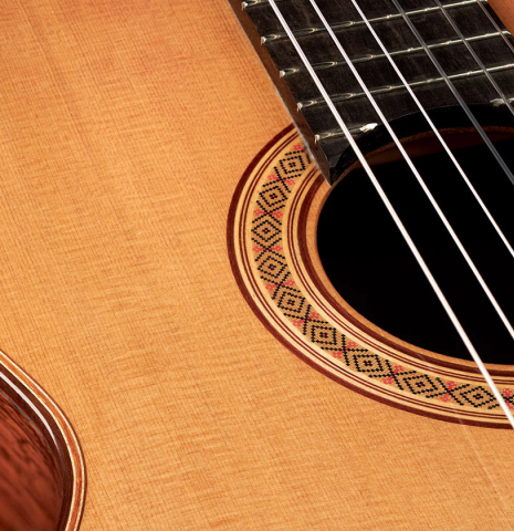 The soundboard and rosette of a 2023 German Vazquez Rubio "Classic Estudio 48" classical guitar made of cedar and palo escrito
