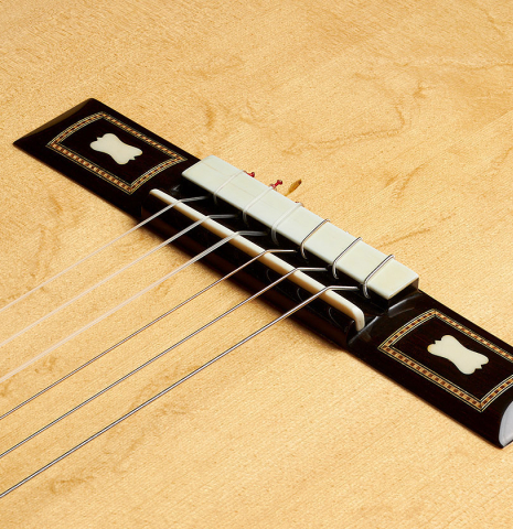 The bridge, tie-block and saddle of a 2012 German Vazquez Rubio "Torres" made of spruce and maple