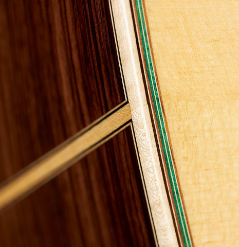 The soundboard and sides at the foot of a 2024 German Vazquez Rubio "Hauser" classical guitar made of spruce and Indian rosewood
