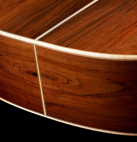 The back and sides at the foot of a 2024 German Vazquez Rubio "Hauser" classical guitar made of spruce and CSA rosewood