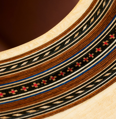 Closeup detail of the rosette of a 2024 German Vazquez Rubio "Solista" classical guitar made of spruce and Brazilian lacewood