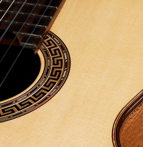 The soundboard and rosette detail of a 2024 German Vazquez Rubio "Solista" classical guitar made of spruce and Brazilian lacewood