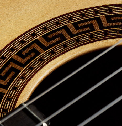 The top and rosette detail of a 2025 German Vazquez Rubio "Solista" classical guitar made of spruce and Brazilian lacewood