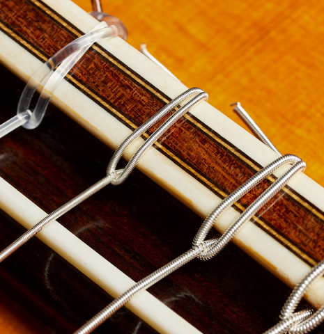 The bridge, tie-block and saddle of a 1969 David Rubio "PF" classical guitar made of spruce and CSA rosewood