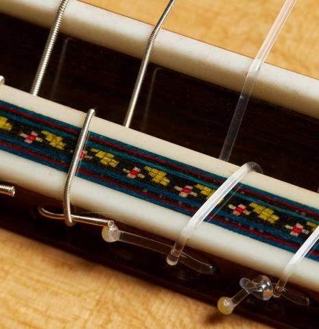 The bridge, tie-block and saddle of a 2024 German Vazquez Rubio "Custom Elite" classical guitar made of spruce and CSA rosewood