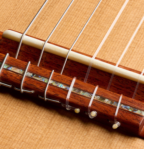 The bridge, tie-block and saddle of a 2026 German Vazquez Rubio "Classic Estudio-SM" classical guitar made of cedar and palo escrito