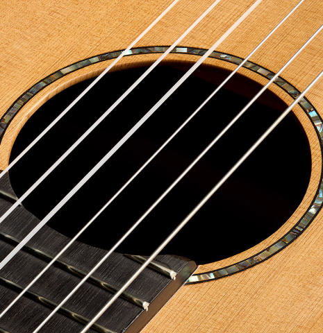 The soundhole and MOP rosette of a 2026 German Vazquez Rubio "Classic Estudio-SM" classical guitar made of cedar and palo escrito