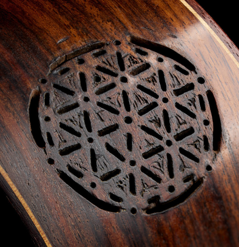The carved sound-port of a 2020 German Vazquez Rubio "Solista" classical guitar made of cedar and Indian rosewood