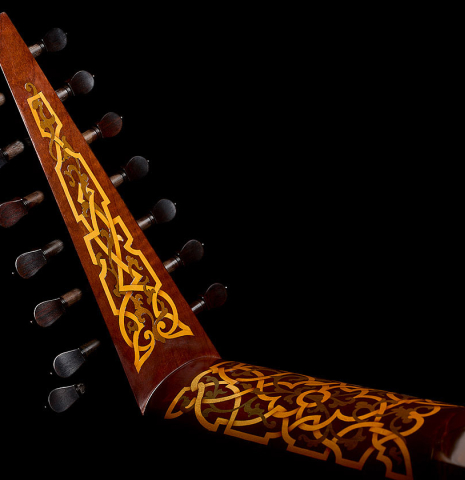 The inlaid neck and head of a 1981 David Rubio 9-course lute made of spruce and maple