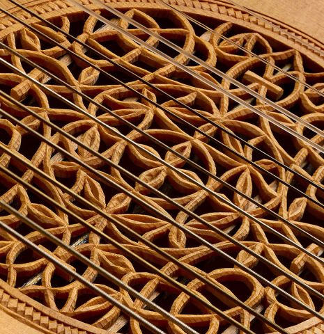 The intricately carved "rose" soundhole of a 1981 David Rubio 9-course lute made of spruce and maple
