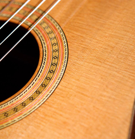 The top and rosette detail of a 2006 Robert Ruck classical guitar made of cedar and Indian rosewood