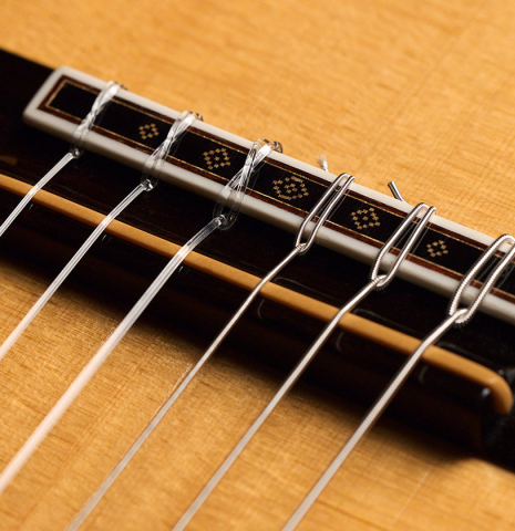 The bridge, tie-block and saddle of a 1983 Robert Ruck classical guitar made of spruce and CSA rosewood The bridge, tie-block and saddle of a 1983 Robert Ruck classical guitar made of spruce and CSA rosewood