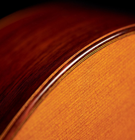 The side, top, binding and purfling of a 2000 Robert Ruck classical guitar made with cedar and Indian rosewood