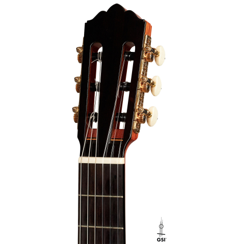 The headstock of a 2000 Robert Ruck classical guitar made with cedar and Indian rosewood on a white background