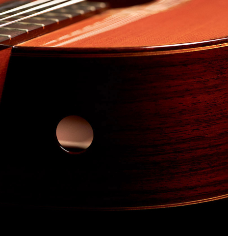 The soundport of a 2000 Robert Ruck classical guitar made with cedar and Indian rosewood