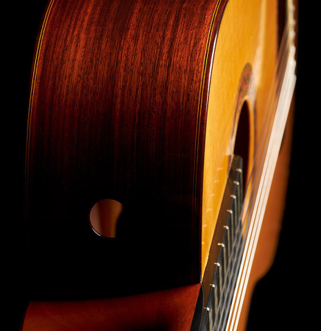 The sides and one of the soundports of a 2000 Robert Ruck classical guitar made of spruce and Indian rosewood
