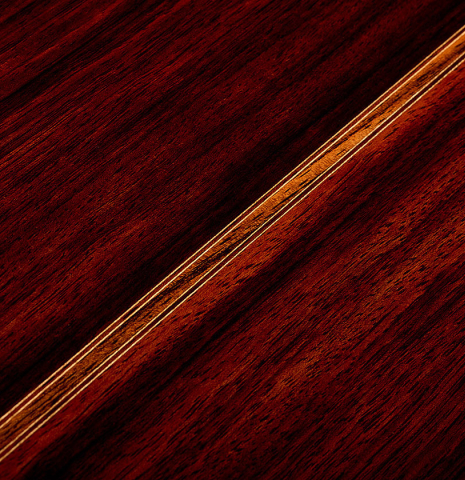 The back center seam and purfling of a 2003 Robert Ruck classical guitar made of spruce and Indian rosewood